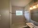 An updated bathroom featuring subway tile, modern fixtures, and a shower-tub combo at 21114 Gladis Ave, Port Charlotte, FL 33952