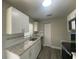 Close up of a kitchen featuring stainless steel appliances, granite countertops, and white cabinets at 21114 Gladis Ave, Port Charlotte, FL 33952