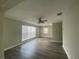Living room with gray floors, ceiling fan, fresh paint, and sun-filled windows at 21114 Gladis Ave, Port Charlotte, FL 33952