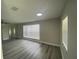 Living room with gray floors, ceiling fan, fresh paint, and sun-filled windows at 21114 Gladis Ave, Port Charlotte, FL 33952