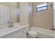 Cozy bathroom with tiled shower, vanity with sink and toilet combination, and neutral color scheme at 2281 Vintage St, Sarasota, FL 34240