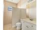 Simple bathroom featuring a tiled shower and neutral color scheme with a white vanity and toilet at 2281 Vintage St, Sarasota, FL 34240