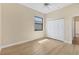 Bright bedroom with neutral walls, light wood floors, a window, and double closet at 2281 Vintage St, Sarasota, FL 34240
