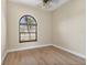 Neutral bedroom boasts a large arched window with views of neighborhood at 2281 Vintage St, Sarasota, FL 34240