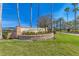 The Laurel Meadows community sign is set amongst beautiful landscaping and palm trees at 2281 Vintage St, Sarasota, FL 34240