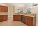 Stylish kitchen featuring modern appliances, wooden cabinetry, and a breakfast bar overlooking the backyard, ideal for casual dining at 2281 Vintage St, Sarasota, FL 34240
