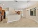 Open-concept kitchen featuring modern appliances, breakfast bar, and seamless flow to dining area, perfect for entertaining at 2281 Vintage St, Sarasota, FL 34240