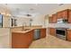 Modern kitchen with stainless appliances, granite counters, and breakfast bar, perfect for everyday meals and entertaining guests at 2281 Vintage St, Sarasota, FL 34240