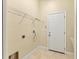 Bright laundry room features a utility sink, shelving, and exterior access door at 2281 Vintage St, Sarasota, FL 34240