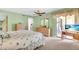 Spacious bedroom with a view to a patio, ceiling fan, and light green walls at 235 Rotonda W Blvd # C102, Rotonda West, FL 33947