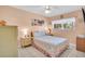 Bright bedroom with tile floor, a queen bed, and two nightstands at 235 Rotonda W Blvd # C102, Rotonda West, FL 33947