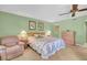 Comfortable bedroom with a cozy armchair, soft carpet, and a ceiling fan at 235 Rotonda W Blvd # C102, Rotonda West, FL 33947