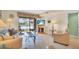 Living room boasts comfortable seating and sliding glass doors to the pool area at 235 Rotonda W Blvd # C102, Rotonda West, FL 33947
