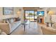 Living room boasts comfortable seating and sliding glass doors to the pool area at 235 Rotonda W Blvd # C102, Rotonda West, FL 33947