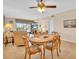 Living and dining area with sliding glass door to screened lanai and pool views at 235 Rotonda W Blvd # C102, Rotonda West, FL 33947