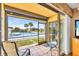 Covered patio with seating overlooks a sparkling pool and tropical landscaping at 235 Rotonda W Blvd # C102, Rotonda West, FL 33947