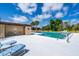 Community pool area with lounge chairs and mature landscaping at 235 Rotonda W Blvd # C102, Rotonda West, FL 33947
