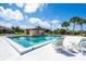 Community pool area with lounge chairs and mature landscaping at 235 Rotonda W Blvd # C102, Rotonda West, FL 33947