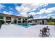Community pool area with lounge chairs and mature landscaping at 235 Rotonda W Blvd # C102, Rotonda West, FL 33947