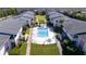 Aerial view of a condo community featuring fenced pool, lawn, lush landscaping at 2505 Beneva Rd # 3, Sarasota, FL 34232