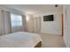 Carpeted bedroom featuring neutral colors, curtains, and a television at 2505 Beneva Rd # 3, Sarasota, FL 34232