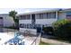 Screened condo balconies near community pool with seating, tables, and lush greenery at 2505 Beneva Rd # 3, Sarasota, FL 34232