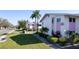View of condos featuring lush landscaping and well-manicured lawn under a clear sky at 2505 Beneva Rd # 3, Sarasota, FL 34232