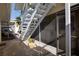 Exterior staircase leading to second-floor apartments, with decorative plants and walkway at 2505 Beneva Rd # 3, Sarasota, FL 34232