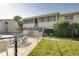 Exterior view of community pool, grass, and two-story condo building at 2505 Beneva Rd # 3, Sarasota, FL 34232