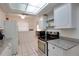 Well-lit kitchen showcasing granite counters, tile flooring, and ample cabinet space at 2505 Beneva Rd # 3, Sarasota, FL 34232