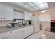 Bright kitchen features white cabinets, granite counters, and modern appliances at 2505 Beneva Rd # 3, Sarasota, FL 34232