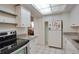 Cozy kitchen with white appliances, granite counters, and tile flooring at 2505 Beneva Rd # 3, Sarasota, FL 34232