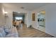 Bright living room showcasing wood floors connecting to the dining area and open kitchen at 2505 Beneva Rd # 3, Sarasota, FL 34232