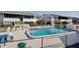 Community pool and white lounge chairs offers a relaxing outdoor space for residents at 2505 Beneva Rd # 3, Sarasota, FL 34232