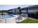 Community pool featuring lounge seating, tables and clear blue skies at 2505 Beneva Rd # 3, Sarasota, FL 34232