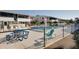 Community pool area surrounded by lounge chairs, picnic tables, and fenced perimeter at 2505 Beneva Rd # 3, Sarasota, FL 34232