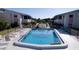 Aerial view of condo community with fenced pool, lounge chairs, and lush landscaping at 2505 Beneva Rd # 3, Sarasota, FL 34232