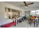 Bright sunroom with tile floor, ceiling fan, bench, and views of the outside at 2505 Beneva Rd # 3, Sarasota, FL 34232