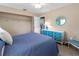 Bedroom featuring blue bedspread and pops of blue color in the accents at 3243 Sunset Beach Dr, Venice, FL 34293