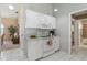 Clean kitchen featuring white cabinets, appliances, tile flooring, and great natural light at 3243 Sunset Beach Dr, Venice, FL 34293