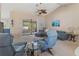 Relaxing living room with comfortable seating, ceiling fan, and sliders to the lanai at 3243 Sunset Beach Dr, Venice, FL 34293