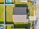 Bird's-eye view of the home showcasing its roof, fenced backyard, and surrounding greenery at 3503 14Th E Ct, Ellenton, FL 34222