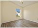 Cozy bedroom showcasing a ceiling fan and scenic backyard views at 3503 14Th E Ct, Ellenton, FL 34222