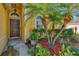 Inviting front entryway with a brown door and tropical landscaping at 3503 14Th E Ct, Ellenton, FL 34222