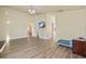 Open-concept living room boasts wood-look floors and abundant natural light at 3503 14Th E Ct, Ellenton, FL 34222