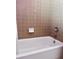 A view of the neutral-colored tiled walls above the bathtub at 3608 67Th Street Ct W, Bradenton, FL 34209