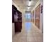 Hallway with wood closets, neutral tile flooring and natural light perfect for storage and organization at 3608 67Th Street Ct W, Bradenton, FL 34209