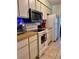 Functional kitchen featuring white appliances, modern microwave, and light countertops for meal preparation at 3608 67Th Street Ct W, Bradenton, FL 34209