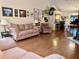 A cozy living room features hardwood floors, a comfortable sofa, and a collection of artwork adorning the walls at 3608 67Th Street Ct W, Bradenton, FL 34209