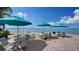 Scenic patio with umbrellas overlooking waterfront, perfect for outdoor dining and socializing at 37 Sunset Dr # 12, Sarasota, FL 34236
